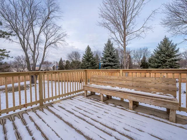 a view of a roof deck with wooden fence and floor