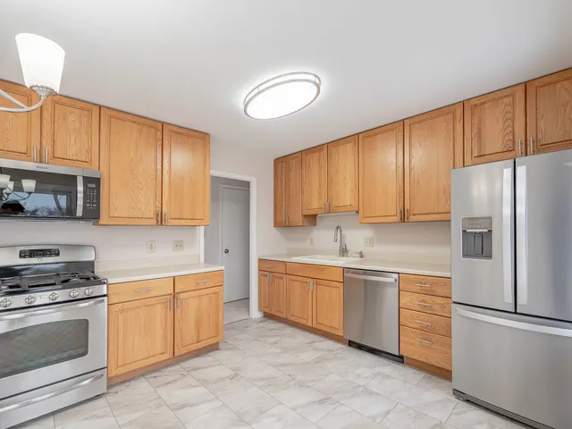 a kitchen with a sink refrigerator and cabinets