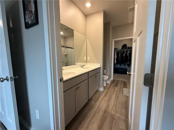 a bathroom with a toilet a sink and shower