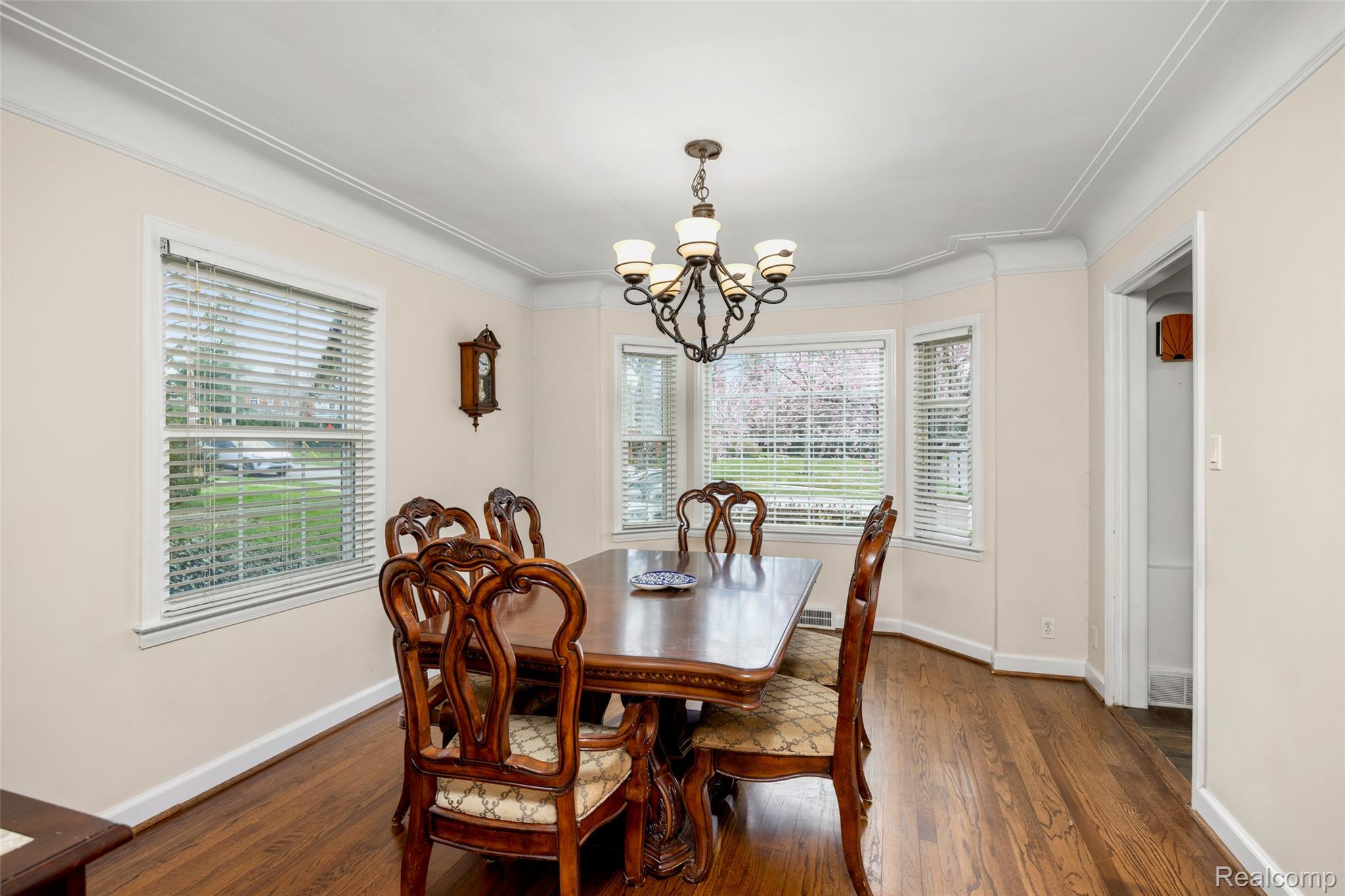 244 Kerby Road Grosse Pointe, MI 48236 - Photo 22 of 53 Dining area with suspended lighting, dark wood-style flooring, and ornamental molding