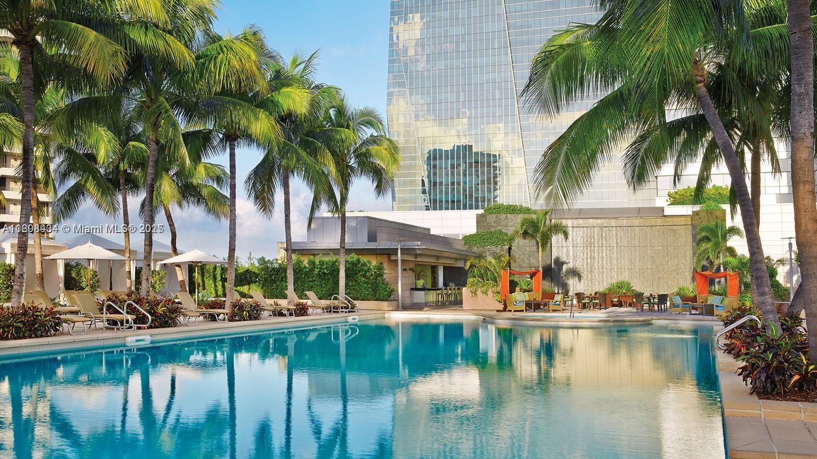 1435 Brickell Avenue, Unit 3307 Miami, FL 33131 - Photo 1 of 77 a view of swimming pool with outdoor seating and house in the background