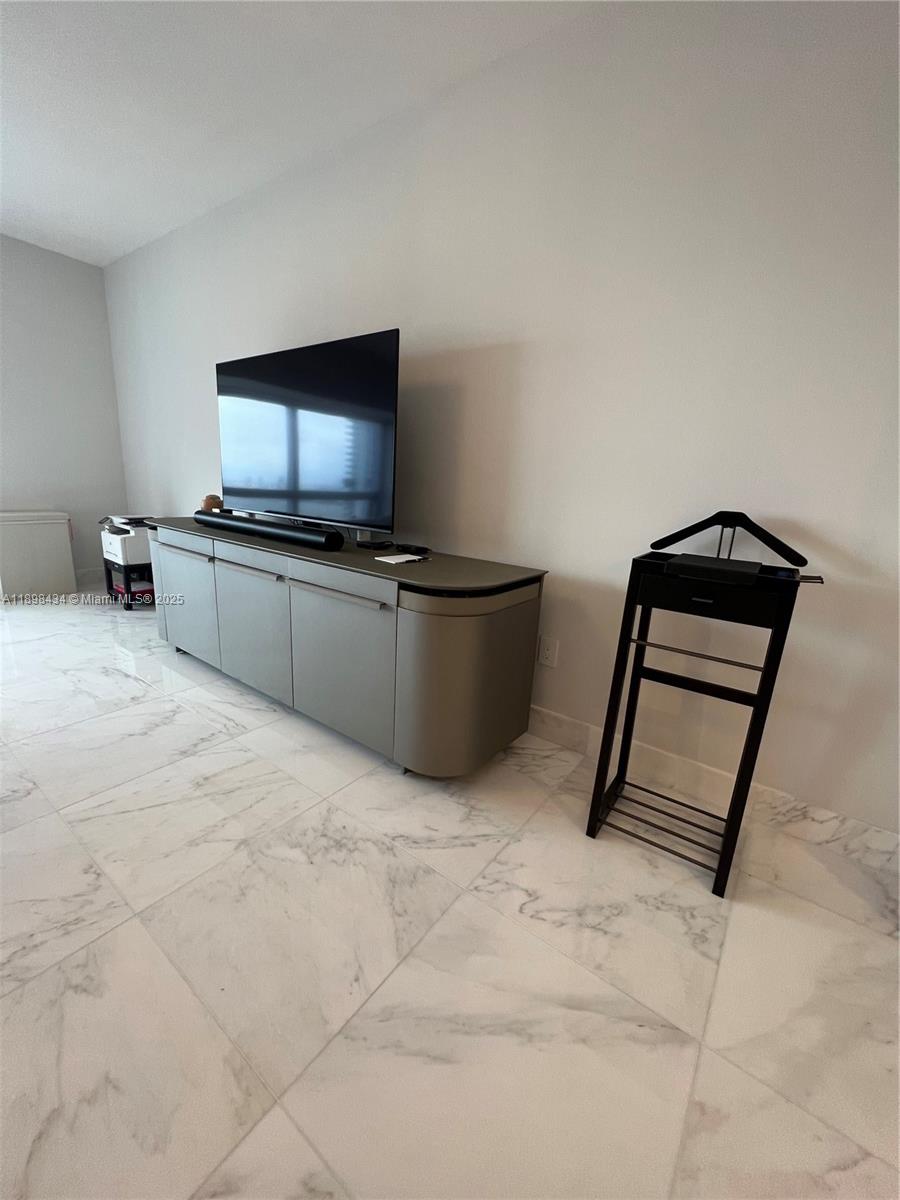 1435 Brickell Avenue, Unit 3307 Miami, FL 33131 - Photo 18 of 77 a living room with furniture and a flat screen tv