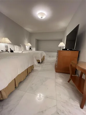 a kitchen with stainless steel appliances granite countertop a table chairs and a sink