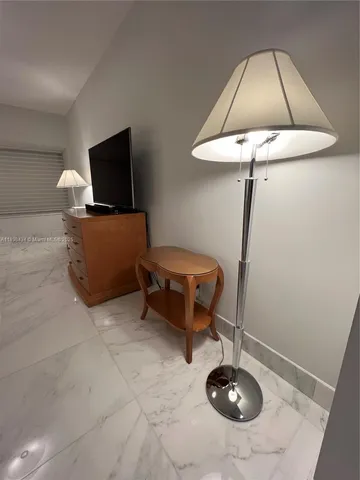 a view of a room with wooden floor and windows