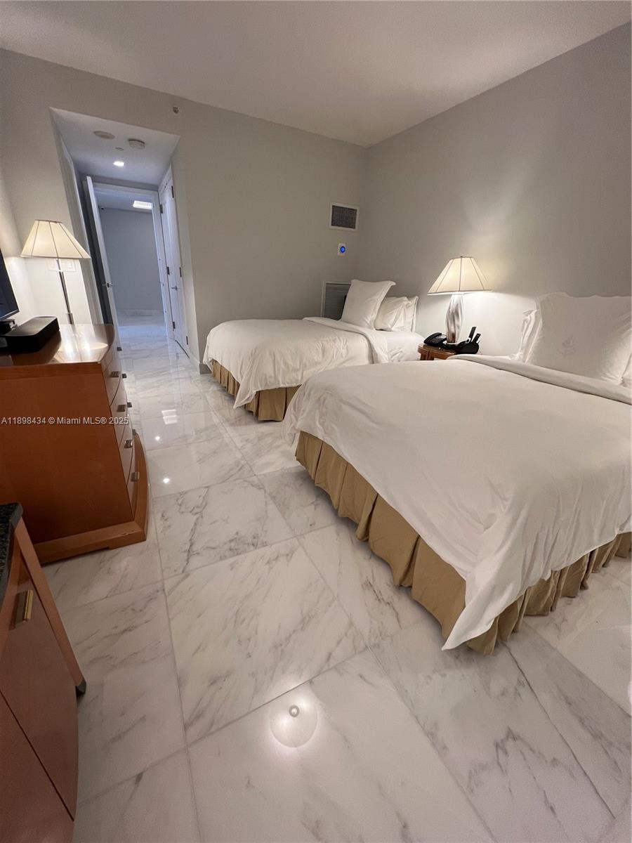 1435 Brickell Avenue, Unit 3307 Miami, FL 33131 - Photo 33 of 77 a bedroom with a bed and a couch