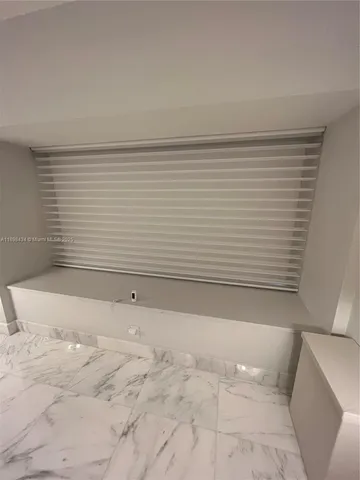 a living room with couches and a large mirror with wooden floor