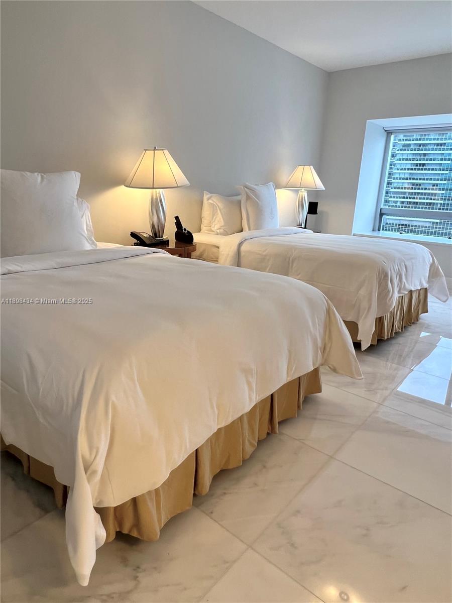 1435 Brickell Avenue, Unit 3307 Miami, FL 33131 - Photo 41 of 77 a bedroom with bed and a night stand