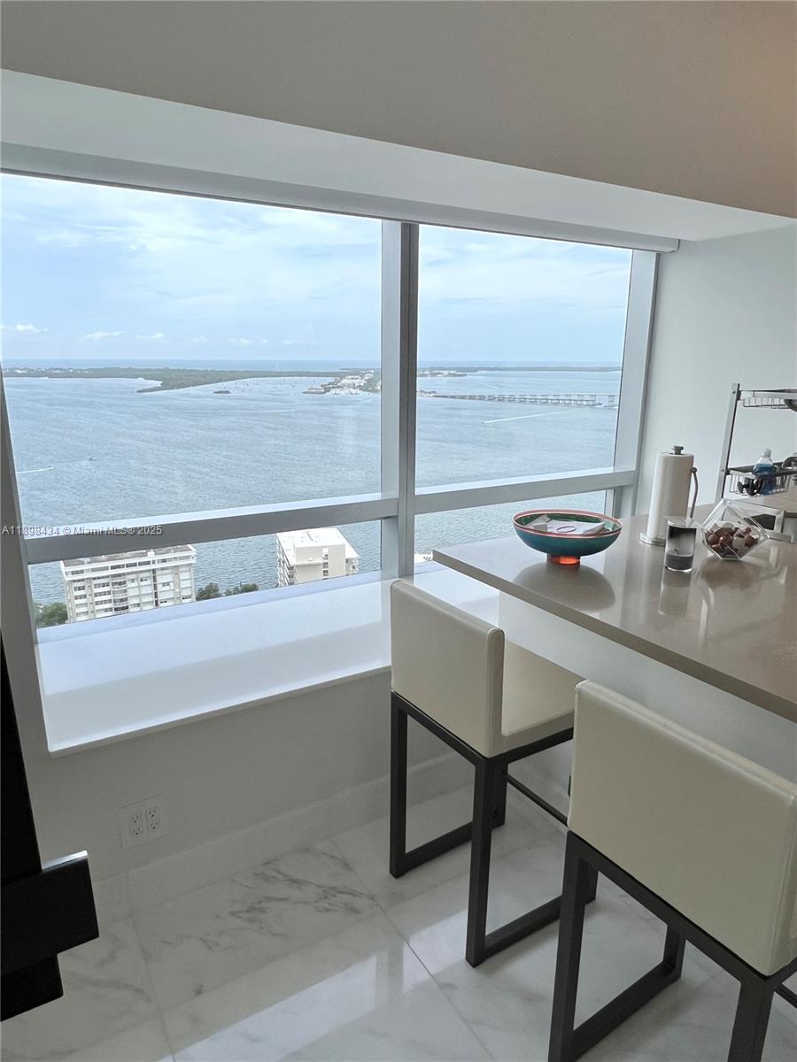 1435 Brickell Avenue, Unit 3307 Miami, FL 33131 - Photo 46 of 77 a view of a room with wooden floor and windows