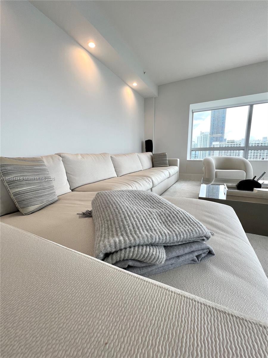 1435 Brickell Avenue, Unit 3307 Miami, FL 33131 - Photo 58 of 77 a living room with a balcony a bed and a large window