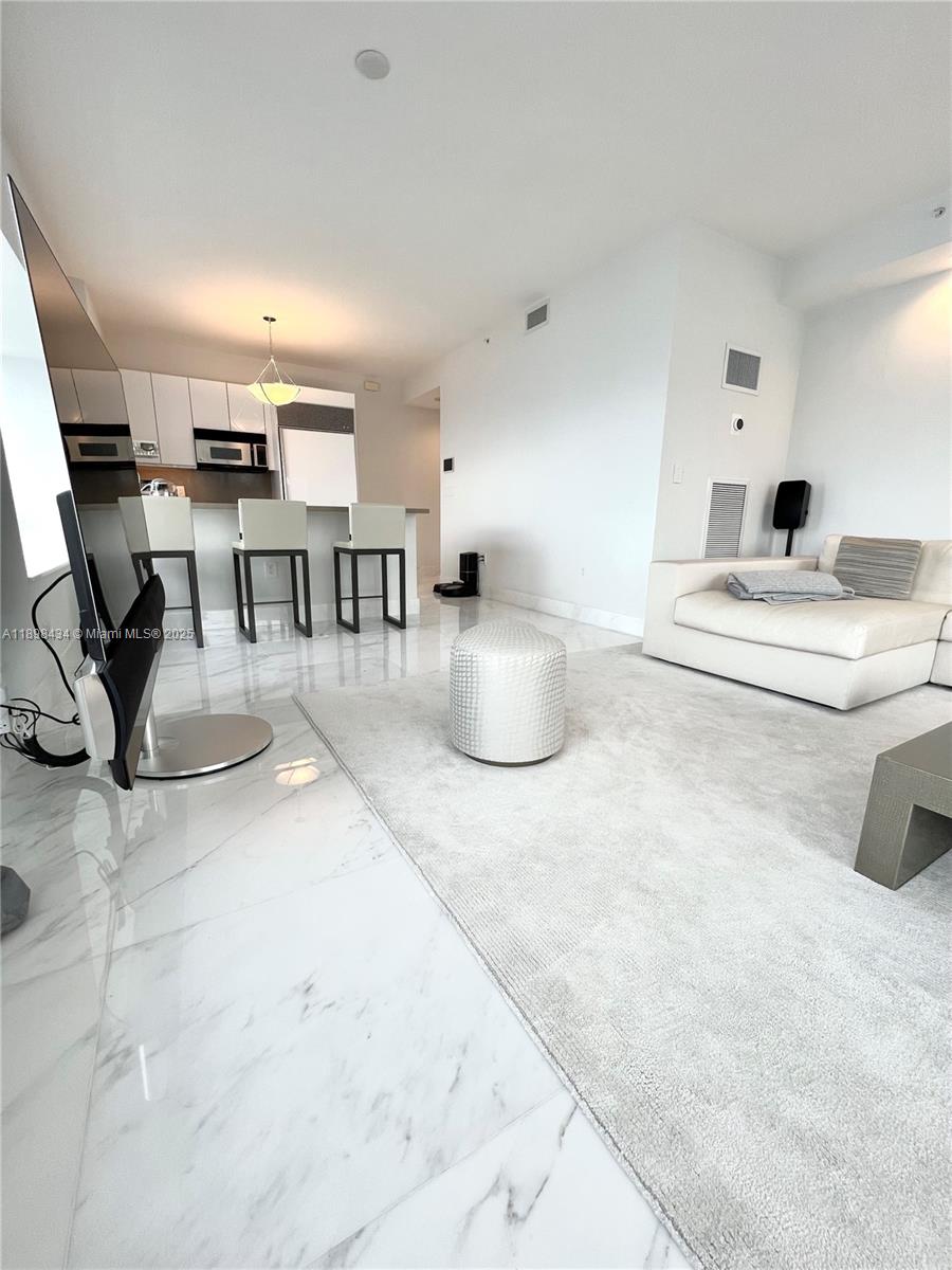 1435 Brickell Avenue, Unit 3307 Miami, FL 33131 - Photo 62 of 77 a living room with furniture and white walls