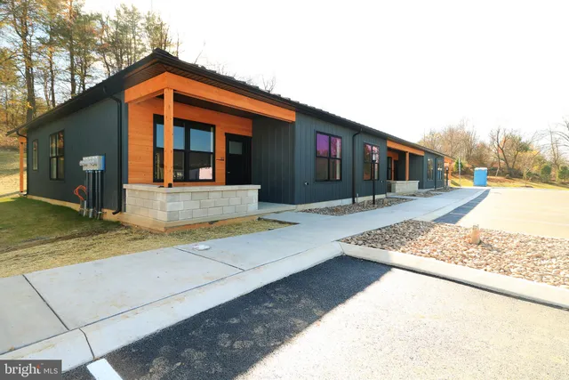 a front view of a house with trees