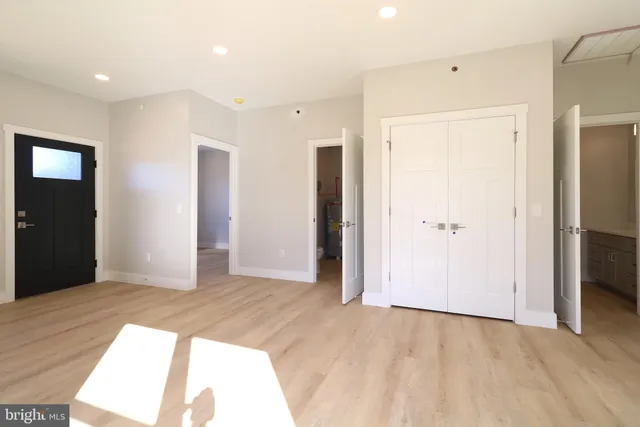 an empty room with windows and closet