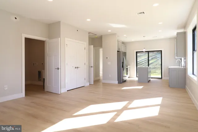 a view of a big room with windows and entryway