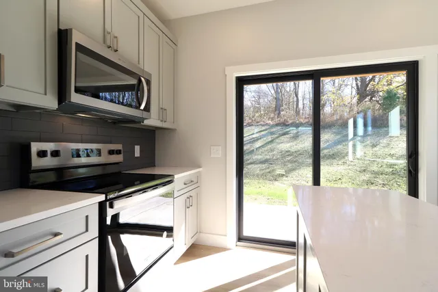 a kitchen with a sink stove top oven and refrigerator