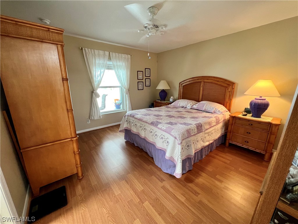 153 Patio Street Lehigh Acres, FL 33974 - Photo 12 of 27 a bedroom with a bed and window