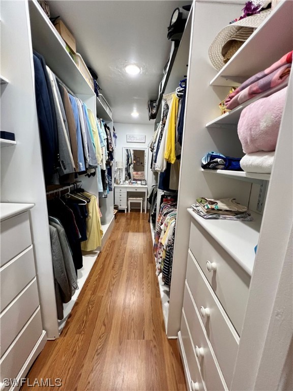 153 Patio Street Lehigh Acres, FL 33974 - Photo 13 of 27 a view of walk in closet with clothes and shoes