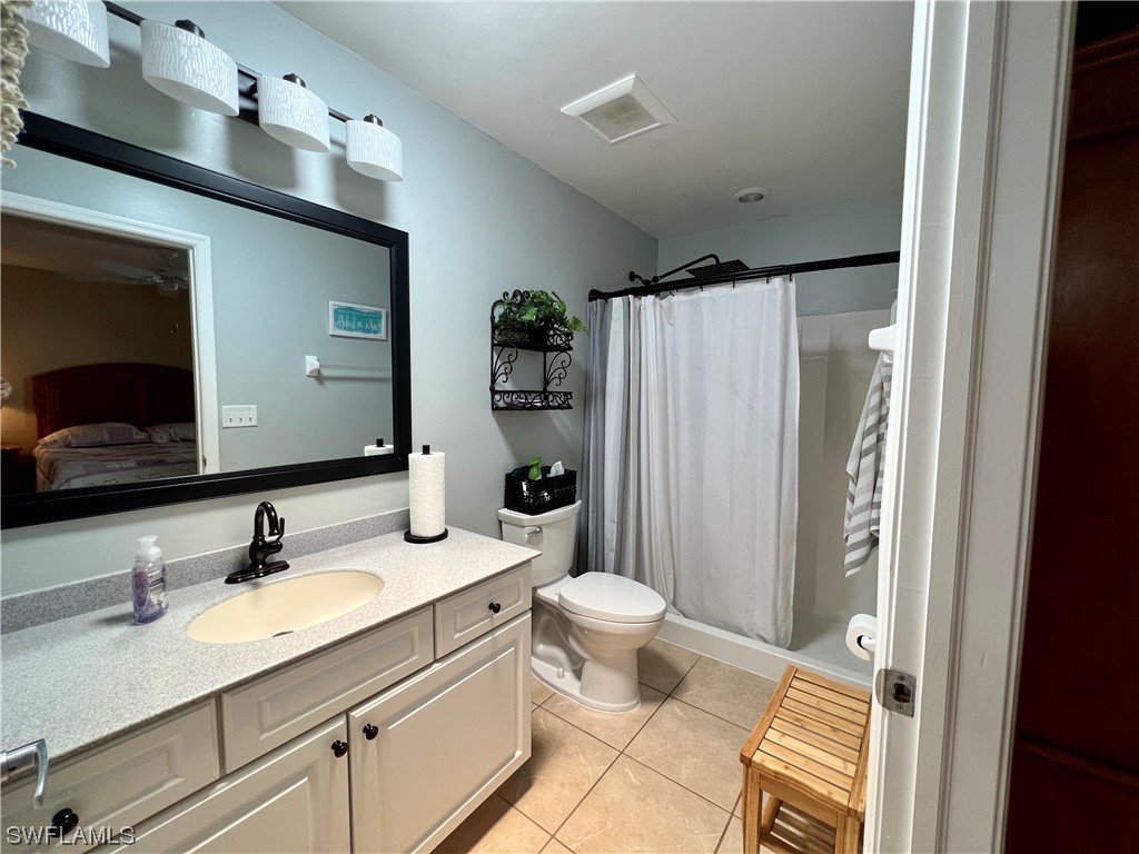 153 Patio Street Lehigh Acres, FL 33974 - Photo 14 of 27 a bathroom with a granite countertop sink toilet and shower