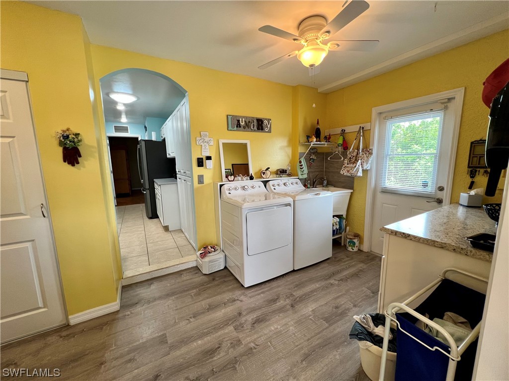 153 Patio Street Lehigh Acres, FL 33974 - Photo 20 of 27 a living room with furniture and a flat screen tv