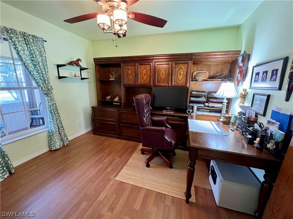 153 Patio Street Lehigh Acres, FL 33974 - Photo 23 of 27 a workspace with furniture and chandelier