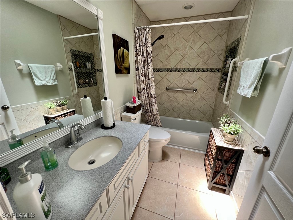 153 Patio Street Lehigh Acres, FL 33974 - Photo 24 of 27 a bathroom with a granite countertop sink toilet and shower