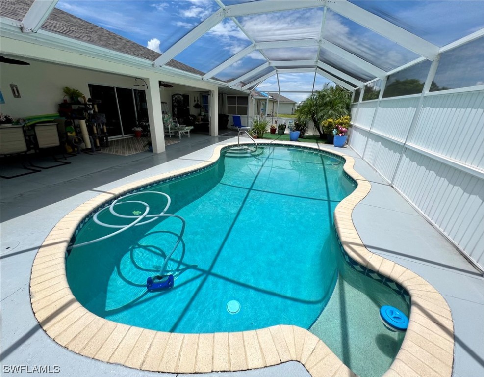 153 Patio Street Lehigh Acres, FL 33974 - Photo 5 of 27 a view of a swimming pool with a patio