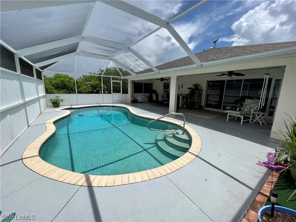 153 Patio Street Lehigh Acres, FL 33974 - Photo 7 of 27 a view of a swimming pool with chairs