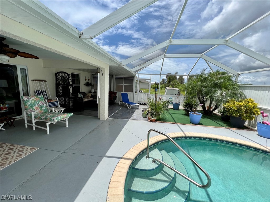 153 Patio Street Lehigh Acres, FL 33974 - Photo 8 of 27 a swimming pool with outdoor seating and yard