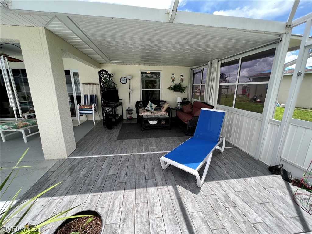 153 Patio Street Lehigh Acres, FL 33974 - Photo 9 of 27 a living room with furniture rug and wooden floor