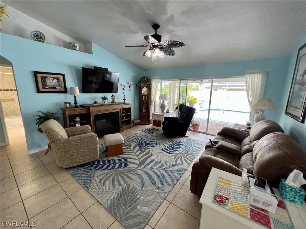 153 Patio Street Lehigh Acres, FL 33974 - Photo 10 of 27 a living room with furniture a flat screen tv and a large window