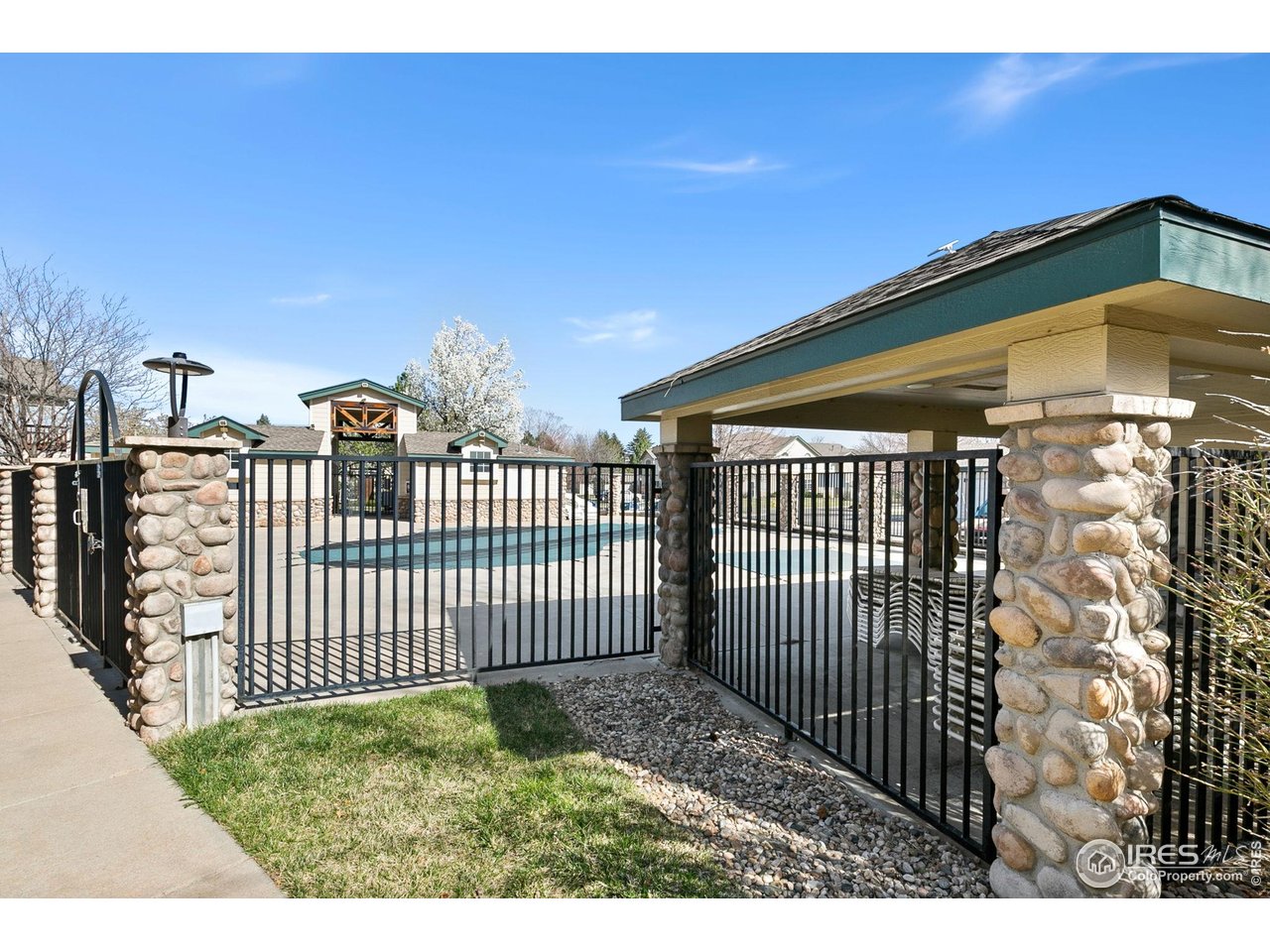 3002 West Elizabeth Street, Unit 1C Fort Collins, CO 80521 - Photo 14 of 15 a backyard of a house with a bench