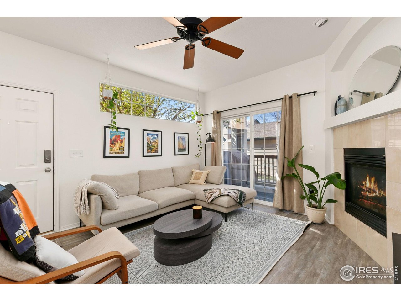 3002 West Elizabeth Street, Unit 1C Fort Collins, CO 80521 - Photo 2 of 15 a living room with furniture a fireplace and a flat screen tv