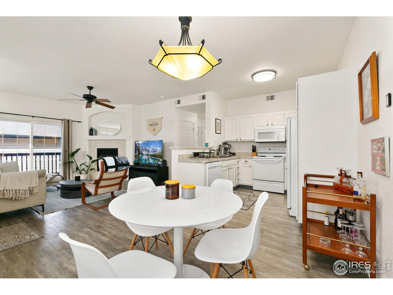 3002 West Elizabeth Street, Unit 1C Fort Collins, CO 80521 - Photo 3 of 15 a living room with furniture kitchen view and a chandelier