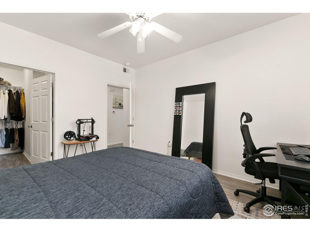 3002 West Elizabeth Street, Unit 1C Fort Collins, CO 80521 - Photo 9 of 15 a bedroom with a bed and a chandelier