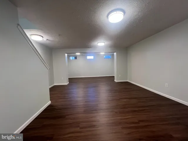 a view of room with wooden floor