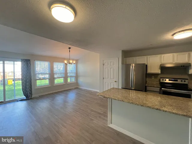a view of a kitchen with a sink and a dishwasher