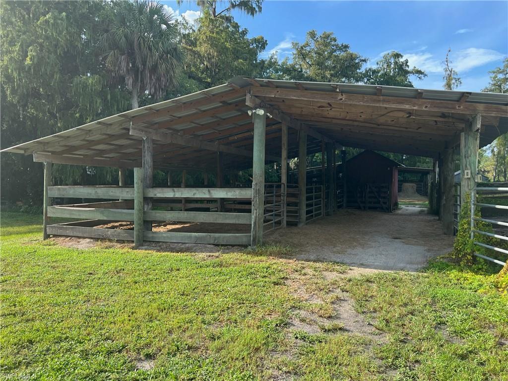 2170 Rock Road Naples, FL 34120 - Photo 3 of 15 a view of backyard with wooden fence and large trees