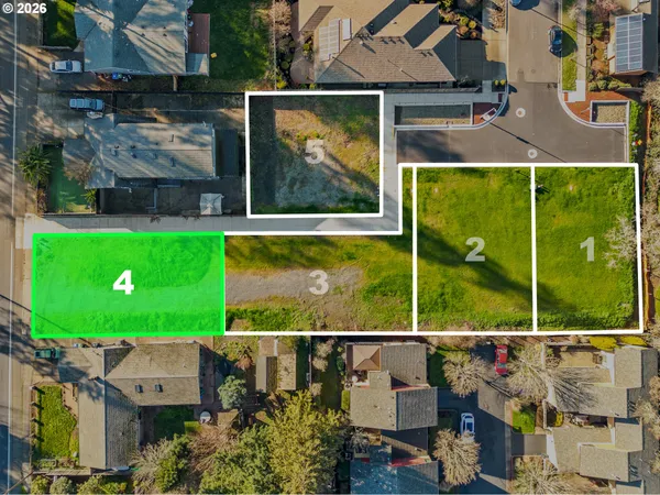 an aerial view of residential houses with yard