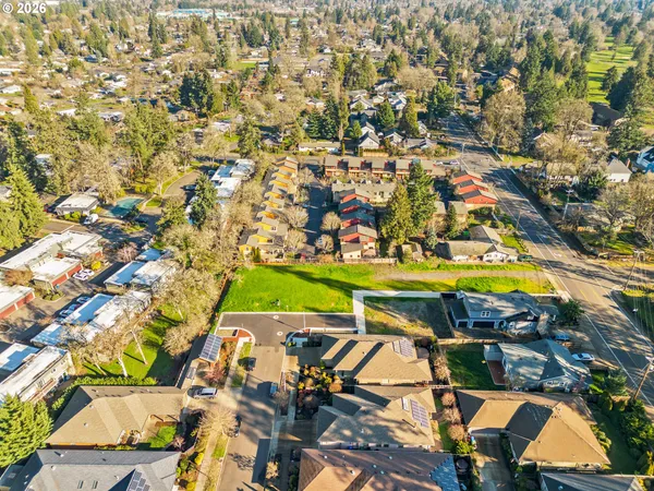 an aerial view of residential house with yard and mountain view in back