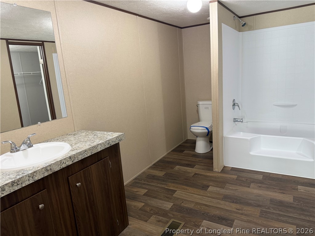 4339 Saddletree Road Lumberton, NC 28360 - Photo 16 of 23 a bathroom with a granite countertop sink toilet and shower