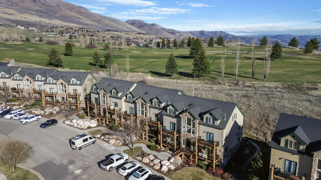 3598 North Huntsman Path, Unit 502 Eden, UT 84310 - Photo 37 of 43 Drone / aerial view of a mountain backdrop and a golf club
