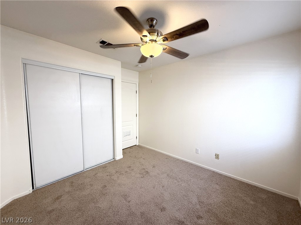 8870 Haviland Road Las Vegas, NV 89123 - Photo 13 of 22 A comfortable bedroom, featuring a convenient sliding closet and plush carpeted flooring.