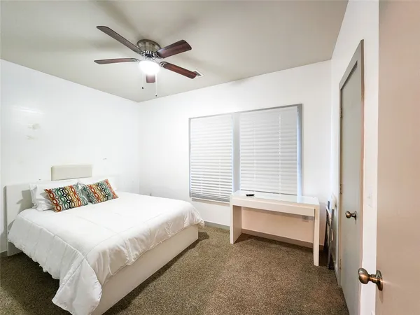 a bedroom with a bed and window