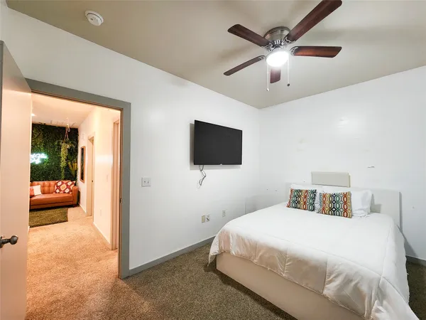 a bedroom with a bed and a flat screen tv