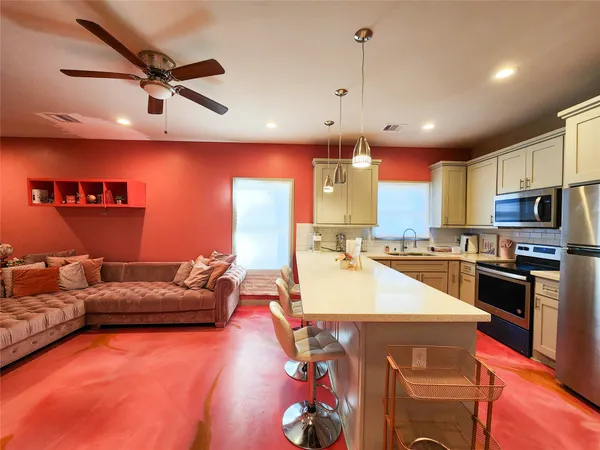 a living room with furniture and kitchen view