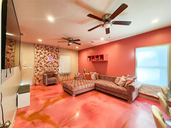 a living room with furniture ceiling fan and a rug