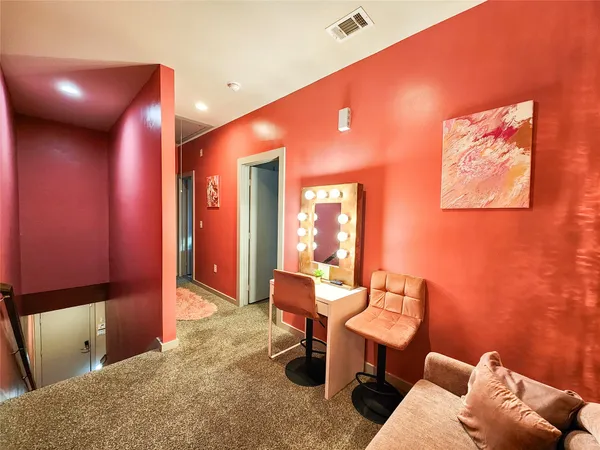 a living room with furniture a desk and chair