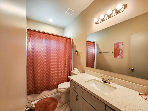 a bathroom with a sink a toilet and mirror