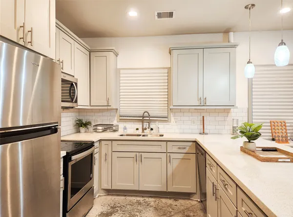 a kitchen with a sink stove and refrigerator