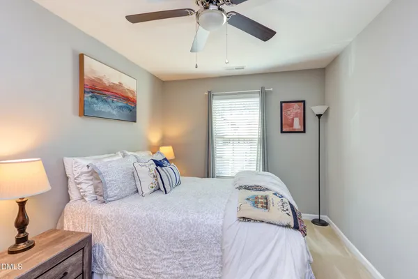 a bedroom with a bed and a lamp