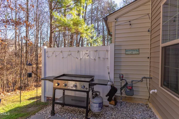 a backyard of a house with table and chairs